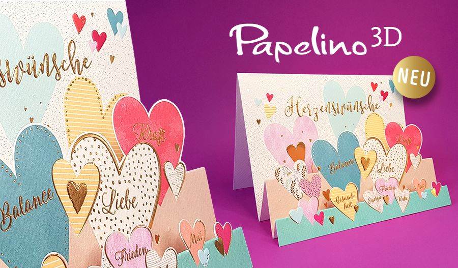 Bunte 3D-Grußkarten mit Herzen und goldenem Schriftzug auf einem leuchtend rosa Hintergrund.
